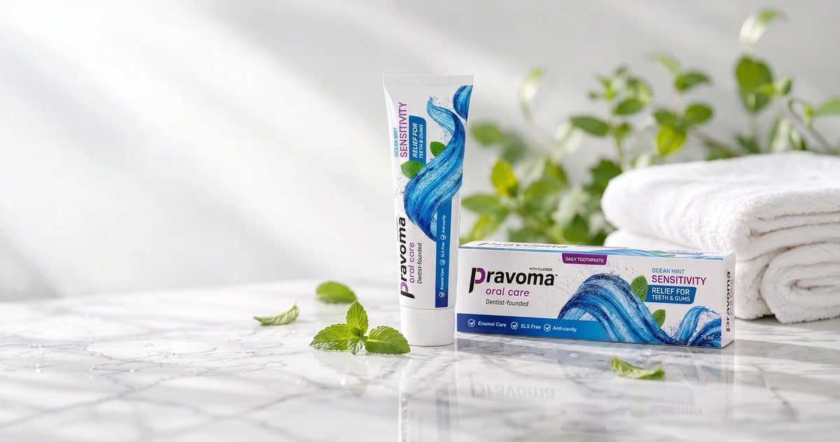 Pravoma Oral Care Ocean Mint Sensitivity toothpaste tube and box on a marble surface with fresh mint leaves